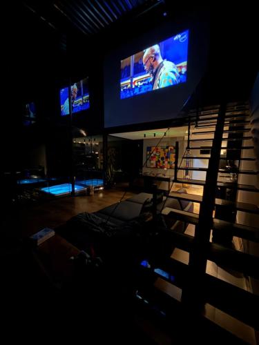 a view of a stage with two televisions on at Casa Vilas Boas Macacos in Nova Lima