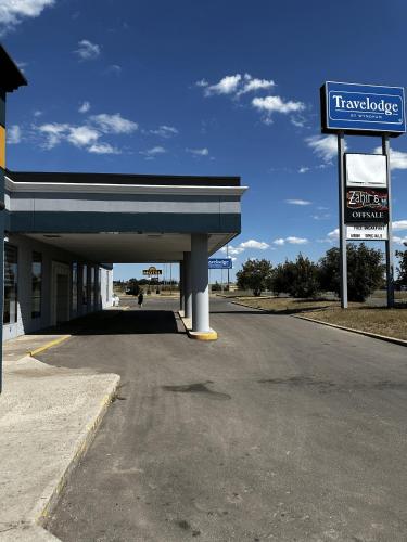 a view of a gas station with a sign at Travelodge by Wyndham Regina in Regina