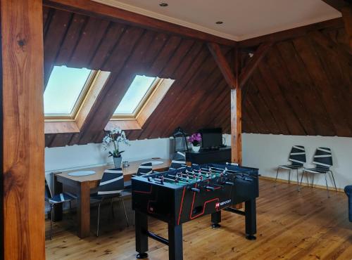 a kitchen with a stove and a table with chairs at Strefa ZEN z Jacuzzi i Basenem in Żerniki Wroctawskie
