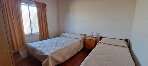 En eller flere senge i et værelse på Casa Tierra