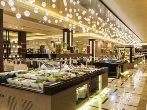 a buffet line with food on display in a restaurant at Rixos Premium Seagate in Sharm El Sheikh
