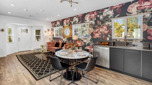 a kitchen and living room with a table and chairs at Art Deco by AvantStay in Los Angeles