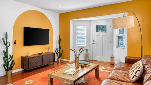 a living room with a couch and a tv at Southwest by AvantStay in Los Angeles