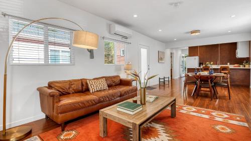 a living room with a couch and a table at Southwest by AvantStay in Los Angeles