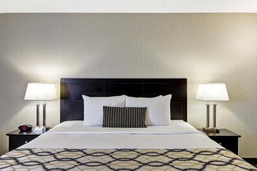 a bedroom with a large bed with two lamps at Radisson Hotel & Conference Centre Edmonton in Edmonton