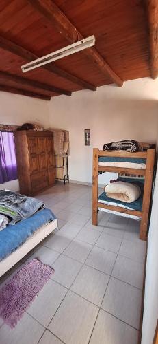 a room with two bunk beds and a tile floor at Bungalow "El Poli 01" in San José