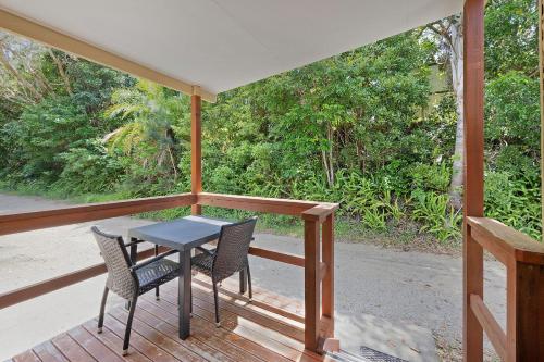 a patio with a table and chairs on a porch at Reflections Nambucca Heads - Holiday Park in Nambucca Heads