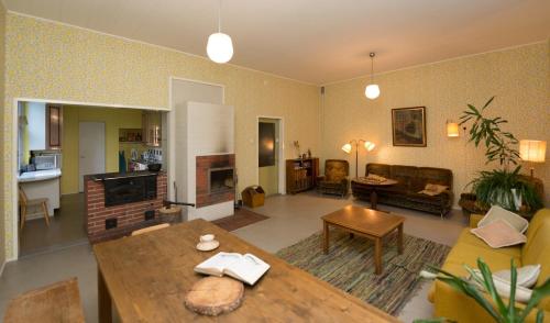 a living room with a couch and a table at Old Hospital & Sauna at the Beach in Pargas