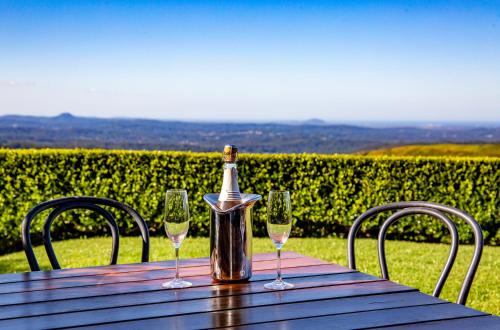 a bottle of wine sitting on a table with glasses at Maleny Views Motel in Maleny