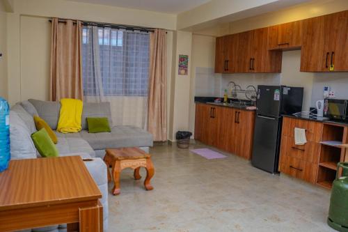 a living room with a couch and a kitchen at Nanyukihomes3 in Nanyuki