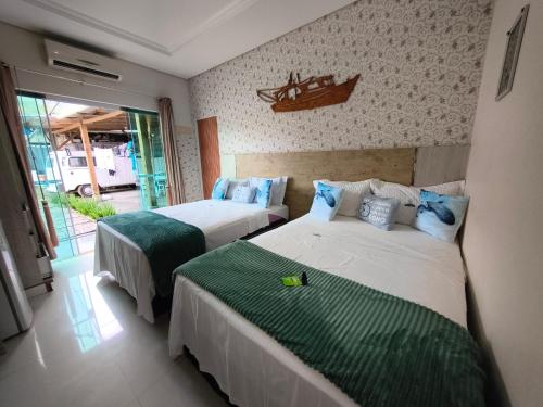 En eller flere senge i et værelse på Pousada Mulher Do Mar