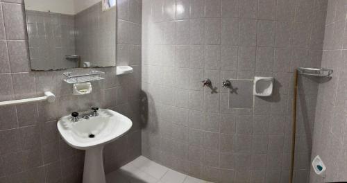 a small bathroom with a sink and a shower at Casa zona CUCÚ de 2 dormitorios in Villa Carlos Paz