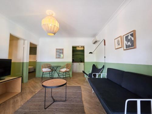 a living room with a couch and a table and chairs at El Toro Motel in Warwick Farm