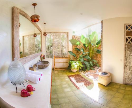 a bathroom with a sink and a mirror at The Shala Bali in Ubud