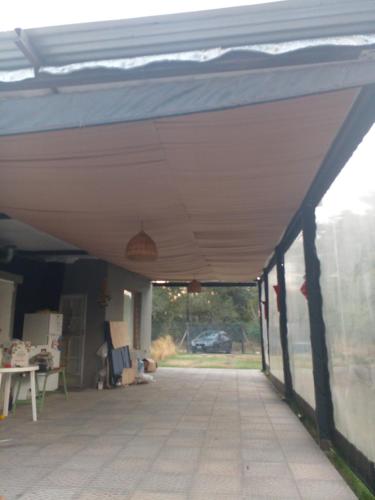 awning over a porch of a house at Aires Verdes in General Pico