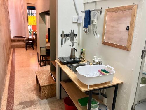 a small kitchen with a sink and a counter at Bang Chak Studio in Bangkok