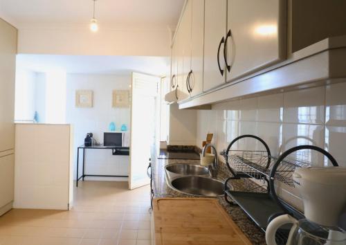 a kitchen with a sink and a counter at Barramares Pool & Beach in Ovar