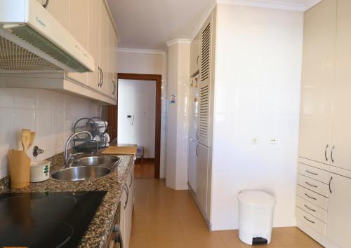 a kitchen with a sink and a counter at Barramares Pool & Beach in Ovar