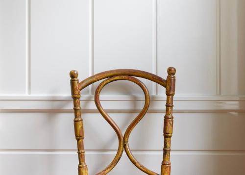 a wooden chair in front of a white wall at Greydon House in Nantucket