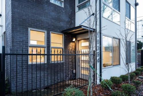 a house with a black fence in front of it at Brand New 3B2B Designer Home near SeaTac in Seattle