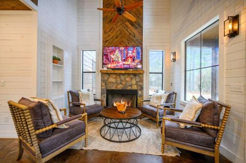 a living room with chairs and a fireplace at Amazing Views Hot Tub Fire Pit Dog Friendly in Stephens Gap