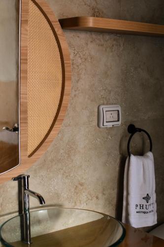a sink in a bathroom with a mirror and a towel at Phuyu Hotel in Mendoza
