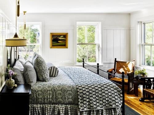 a bedroom with a bed and windows at Greydon House in Nantucket