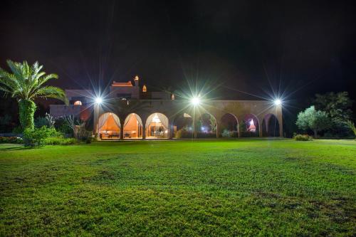 a house lit up at night with lights at Ksar Salha in Marrakech
