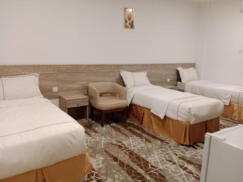 Ein Bett oder Betten in einem Zimmer der Unterkunft فندق اوتاد البدر الششه