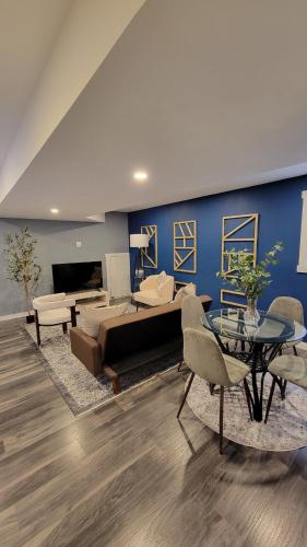 a living room with a bed and a table at Beautiful newly designed Luxurious Apartment in Windsor