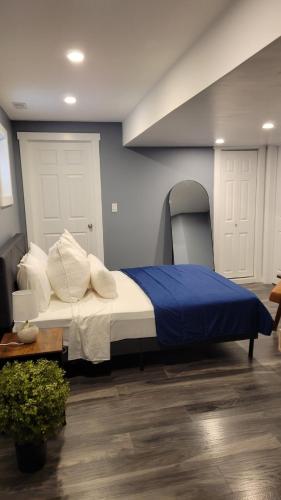 a bedroom with a bed with a blue wall at Beautiful newly designed Luxurious Apartment in Windsor