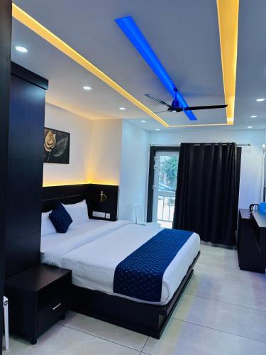 a bedroom with a bed with a blue ceiling at G Mount inn in Munnar