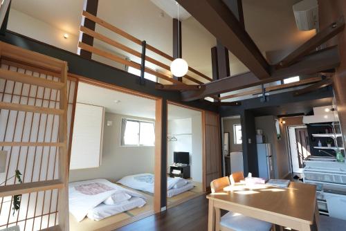 a room with a bed and a desk and a table at Life House Tamatsukuri Osaka Castle in Osaka