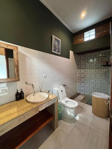 a bathroom with a sink and a toilet at Sutji living in Sanur