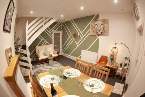 a dining room with a table and chairs and a staircase at Long Eaton Cosy Homestay Close to Town & Station in Long Eaton