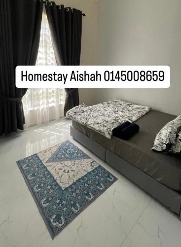 a bedroom with a bed and a rug on the floor at Homestay Aishah in Kota Bharu