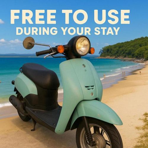 a scooter parked on the beach with the words free to use during your stay at The Nines Noosa in Noosaville