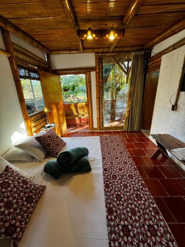 a room with a bed in a room with windows at Cabañas Casa Luna in Rivera