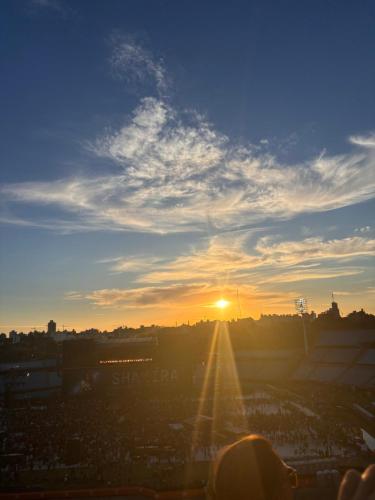 a sunset over a soccer field with the sun in the sky at Tres de Mayo in San Luis