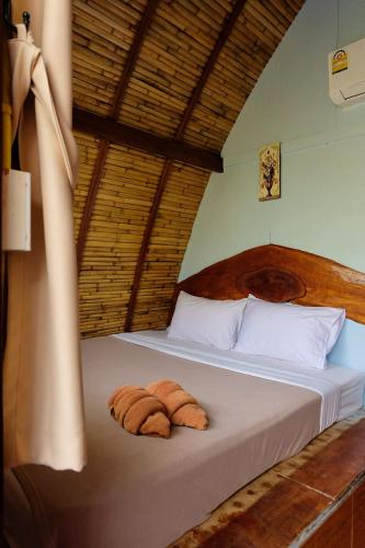 a bedroom with a bed with two towels on it at Lanta Wild Beach Resort in Ko Lanta