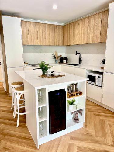a kitchen with a white island in a room at The Nines Noosa in Noosaville