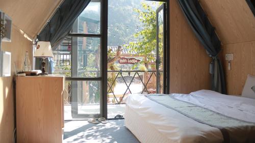 En eller flere senge i et værelse på Pavi Lodge