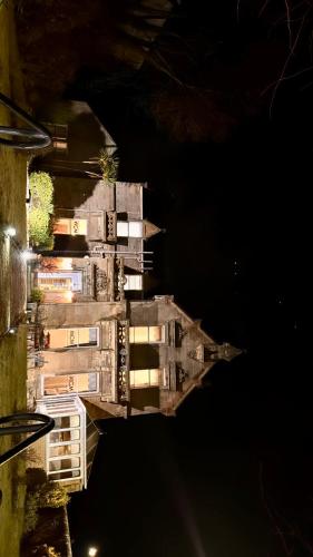 a building at night with its lights on at West Coates Mansion in Edinburgh