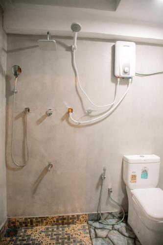 a bathroom with a shower and a toilet at Hiri First In Rest in Dickwella