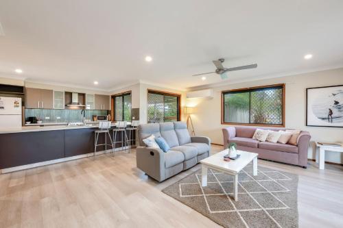 a living room with a couch and a table at 12 Wilfred Street in Bargara