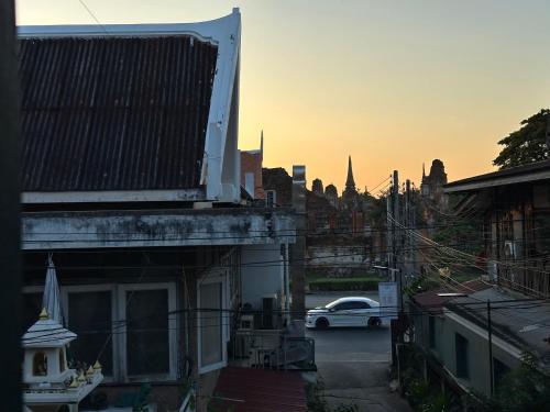 a car driving down a street in a city at The Florist Ayutthaya in Phra Nakhon Si Ayutthaya