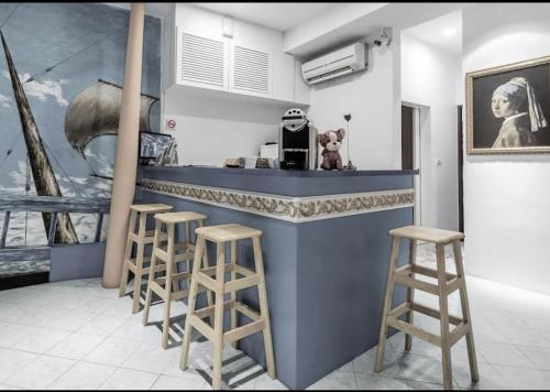 a kitchen with a blue counter and stools at Chihkan Mansion in Tainan