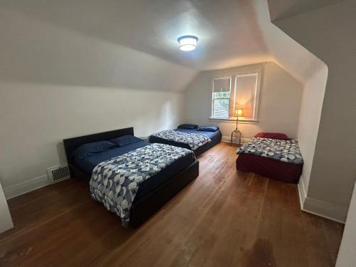a bedroom with two beds and two ottomans at Vancouver Guest House - Airport 10 Min - Free Parking & Fast Wi-Fi in Vancouver