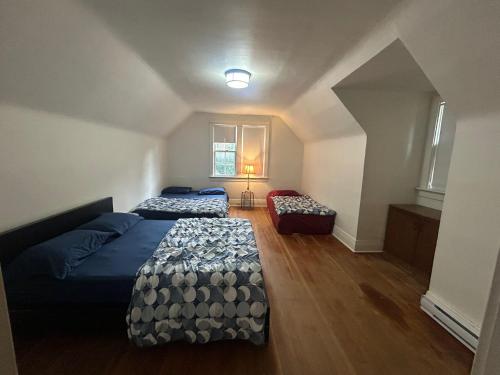 a large room with two beds and a couch at Vancouver Guest House - Airport 10 Min - Free Parking & Fast Wi-Fi in Vancouver