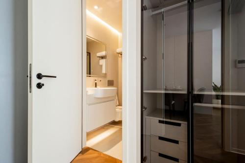 a bathroom with a toilet and a sink at Kora 2br pool Apartment in Layan Beach